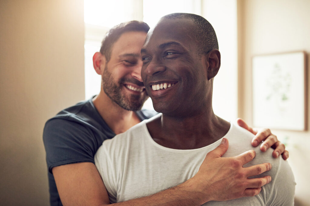 Black and white gay couple smiling